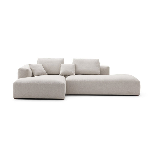 The 5th Open 116" Left Facing Sectional is a modern, minimalist beige sectional sofa featuring clean lines and plush cushions. It includes a chaise lounge on one side, perfect for a contemporary living room setting, and is showcased against a white background.