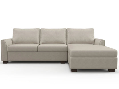 The Tiffany Chaise 96" Sofa is a light gray sectional with three cushioned seats and a right-side chaise lounge. It showcases modern, simple lines with wooden block legs, all set against a plain white background.