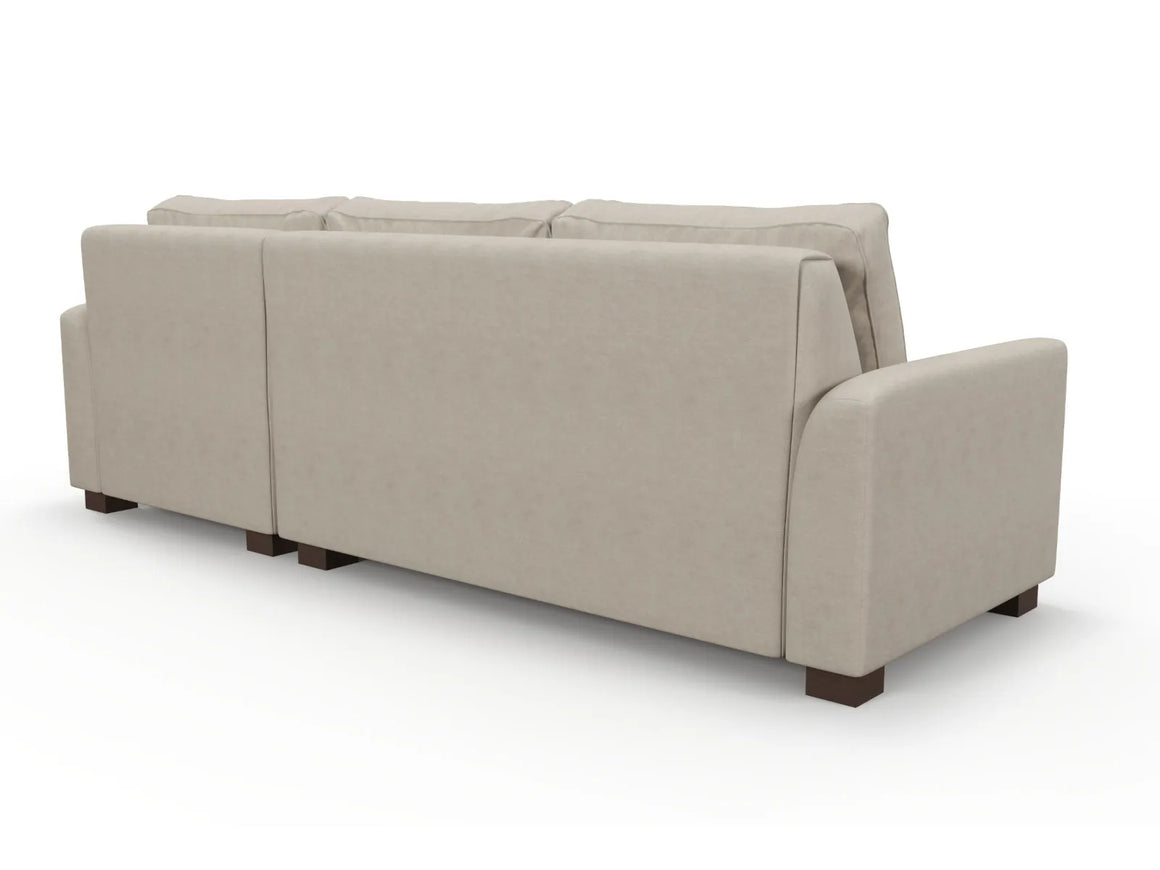 The Tiffany Chaise 96" Sofa in beige is showcased from the back, displaying three cushion segments and wide armrests, supported by four dark wooden legs.