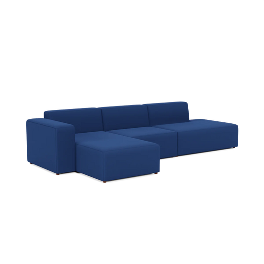 A contemporary Three-Seater Form Sectional in a rich deep blue fabric, showcasing sleek lines and low-profile cushions, set against a white background.