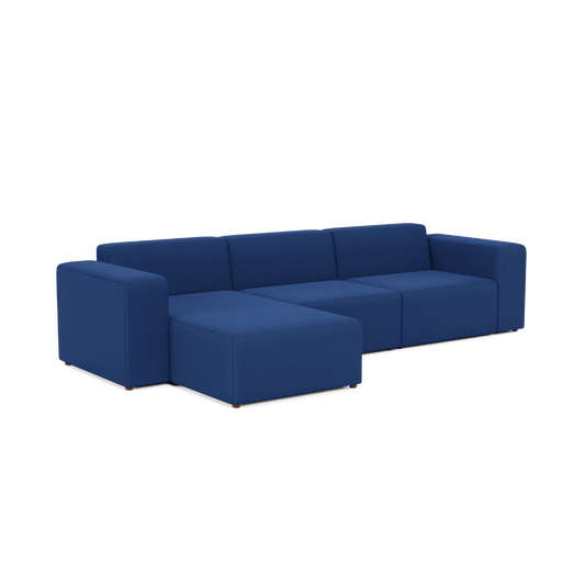 The Three-Seater Form Sectional is a contemporary, modular sofa featuring blue fabric upholstery. It boasts clean lines and a minimalist design, accommodating multiple people comfortably. The sectional includes an attached chaise on the left side.