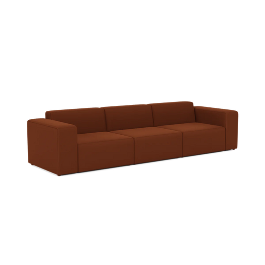 The Three-Seater Form Sectional is a modern sofa with a minimalist design, upholstered in rich brown fabric. It features wide armrests and a low back, providing a contemporary look.