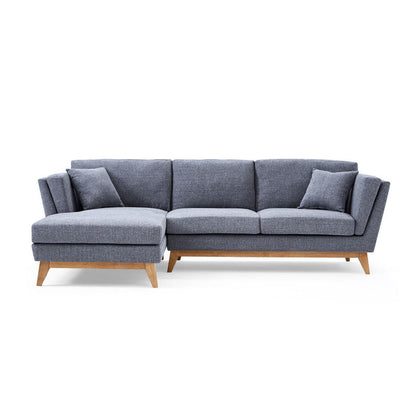 The ValMinimal Sectional is a modern gray sofa with wooden legs and two matching cushions, featuring an L-shaped design with a left-side chaise. Its upholstery appears soft and textured, offering a contemporary and cozy seating option.