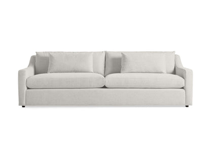 The Ashby Sofa, featuring a light gray design with two seat cushions and two large back cushions along with slightly curved armrests, is placed against a plain white background.