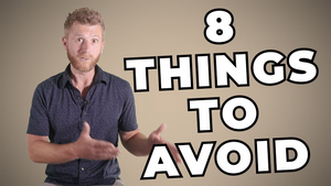 A man with short hair and a short beard is speaking while seated against a beige background. He wears a dark shirt and gestures with his hands. The bold text beside him reads "8 THINGS TO AVOID.