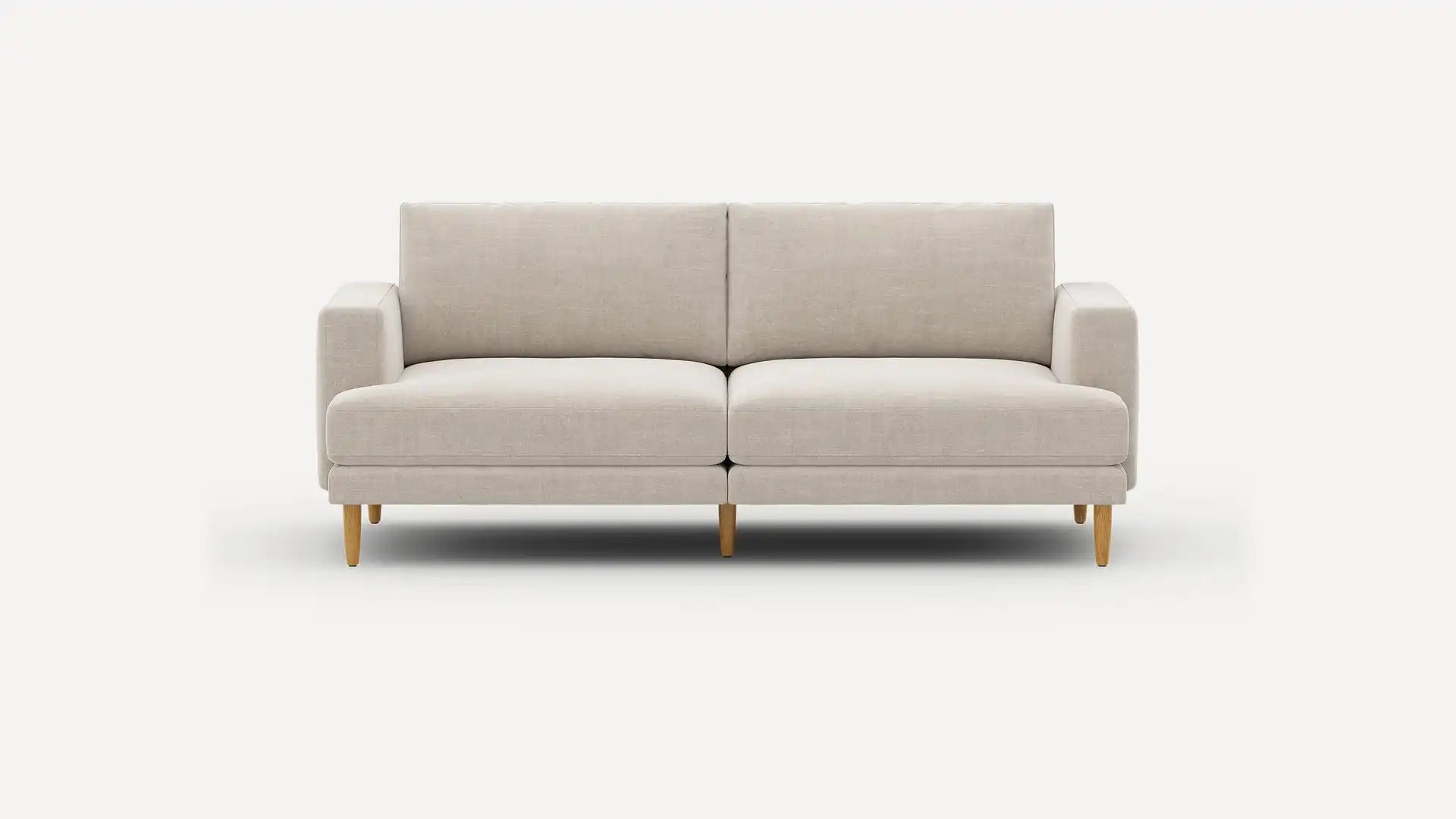 The Ember Mid-Century Modern 75" Sofa, featuring a sleek beige design and wooden legs, is showcased against a plain white background. It boasts a minimalist style with cushioned seats and armrests.