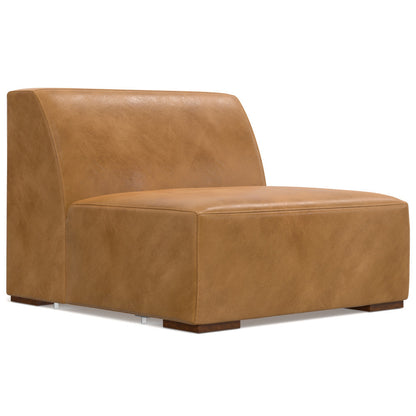 A modern, armless, tan leather chair with a smooth, minimalist design. It features a low backrest and square, sturdy wooden legs. The chair has a sleek and compact appearance with a slightly glossy finish.