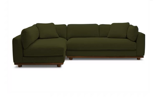 Introducing the Miller Sectional: a dark green L-shaped sofa with elegant wooden legs, featuring three cushions on the backrest and one on the seat, all beautifully presented against a plain white background.