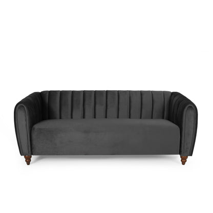 The 3 Seater Sofa Modern Glam Design is a dark gray velvet piece with vertical tufting along the backrest and arms. It has rounded arms, wooden legs, and sits on plain white background, offering a modern and elegant look.