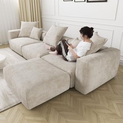 A person is comfortably seated on a spacious black sectional sofa, reading a book. The room highlights a parquet floor, white paneled walls, and sheer curtains that let natural light illuminate the space.