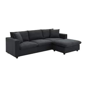 A black, modern sectional sofa in an L-shaped design offers plush corduroy polyester cushions and features a right-side chaise lounge, perfectly suiting a contemporary living room.