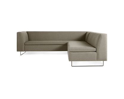 Discover the Bonnie and Clyde Sectional Sofa, an L-shaped piece showcasing a minimalist design in gray fabric upholstery. It features sleek metal legs and padded armrests, along with a low back that offers a contemporary vibe, perfect for enhancing any stylish living room setup.