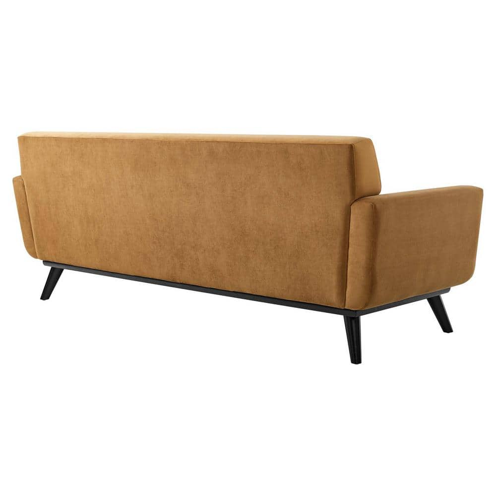 Rear view of the Engage Width 90.5 in. Performance Velvet Sofa in cognac, featuring sleek, angular arms and black tapered legs that provide a minimalist and contemporary design.