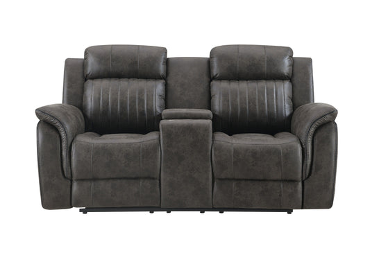 The Steban Console Reclining Loveseat in gray is a dark, plush two-seater with sleek upholstery, featuring subtle stitching on backrests and seats. It offers added comfort with a center console and armrests.