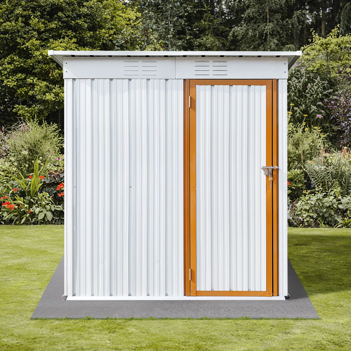 The Garden Sheds 5FtX4Ft Outdoor Storage Shed, a small white metal structure with a sloped roof and wooden-framed door, sits on a lawn, surrounded by a garden filled with plants and greenery, with trees visible in the background.