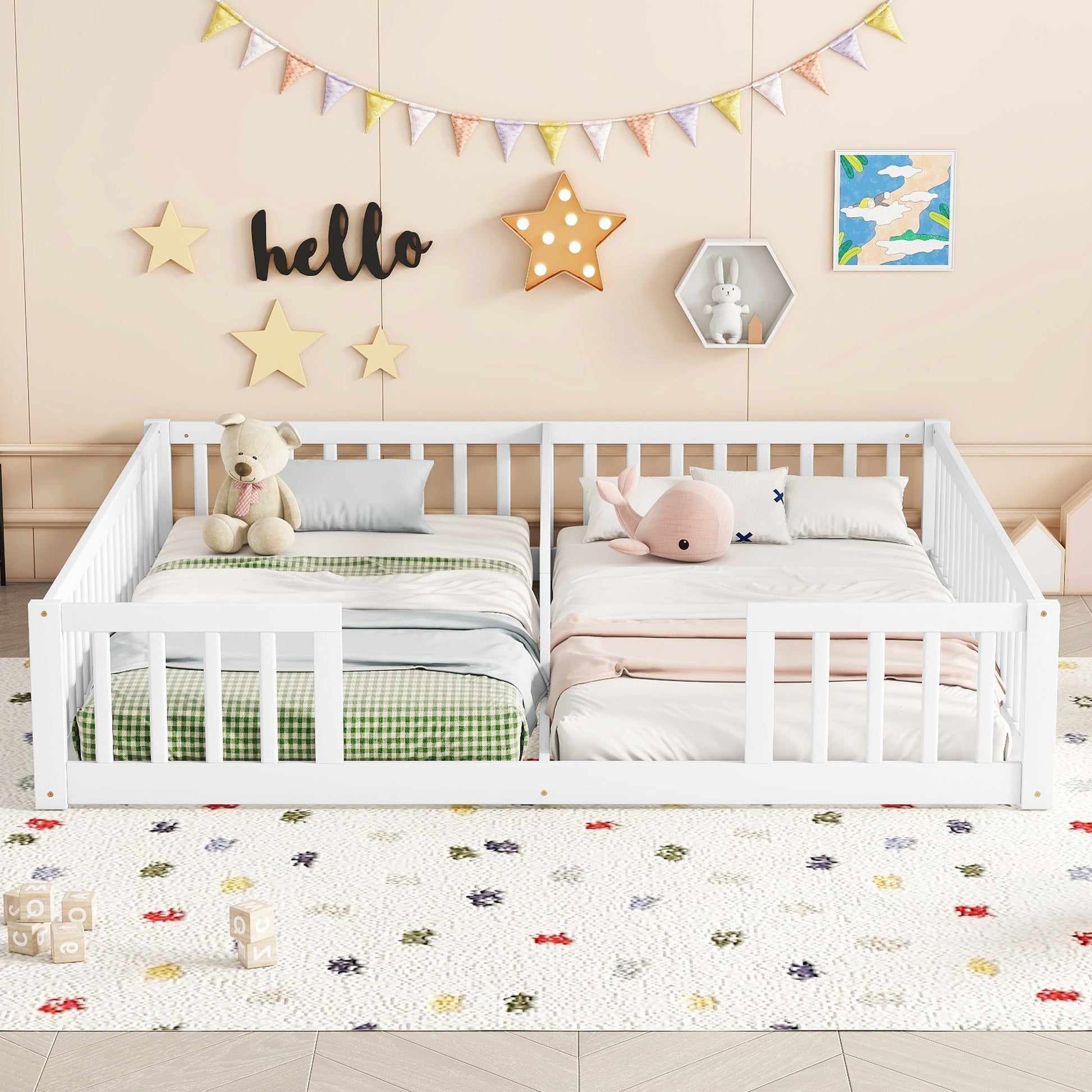 Children's room with two white Double Floor Beds With Fence side by side, adorned with plaid and solid bedding. A plush teddy and pink whale sit atop the beds. The wall features star decor, "hello" sign, and a bunny shelf, while a colorful banner hangs above. The rug has small patterns.