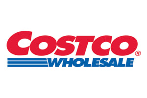 The image shows the logo of Costco Wholesale, with "COSTCO" in bold, red uppercase letters, and "WHOLESALE" in blue uppercase letters below it. There are three horizontal blue lines extending from the left under "WHOLESALE.