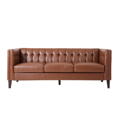 The Comfy 3 Seat Sofa with a tufted back, brown leather finish, three seat cushions, and dark wooden legs is shown against a white background.