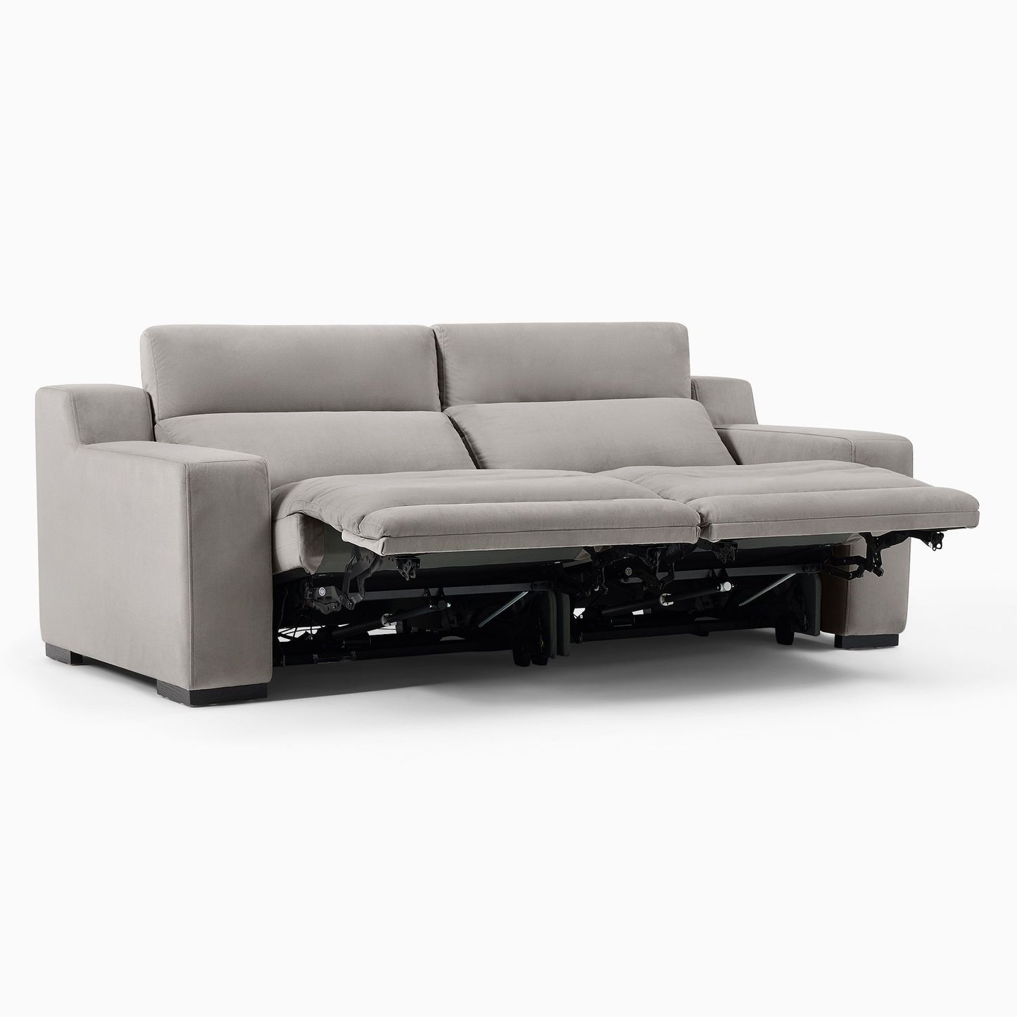 The Dalton Motion Sofa, featuring a contemporary beige design with two cushioned backrests and extended reclining footrests on both sides, is set against a plain white background.