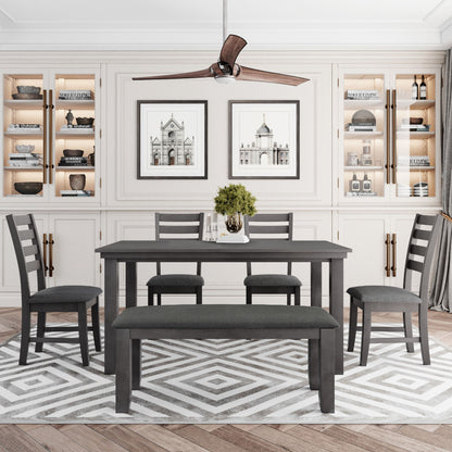 A modern dining room features a gray rustic wood dining set with a table, four chairs, and a bench on a geometric rug. The background has built-in shelves with decor and two architectural prints, while a ceiling fan hangs above.