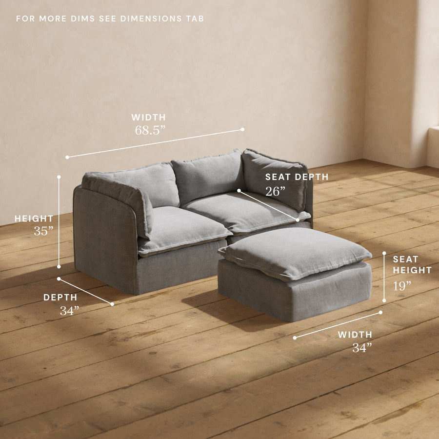 A Modular Performance 2-Seater and Ottoman in grey upholstery are situated on a wooden floor. The dimensions are indicated as follows: the 2-seater width is 68.5", depth is 34", and height is 35"; the ottoman width is 34", depth is 34", with a seat depth of 26" and a seat height of 19".