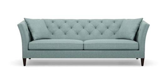 The Shelton 98" Sofa is a stylish piece, featuring a tufted backrest and two seat cushions in a chic teal color. It boasts flared armrests and rests on dark wooden legs, seamlessly combining contemporary design with comfort.