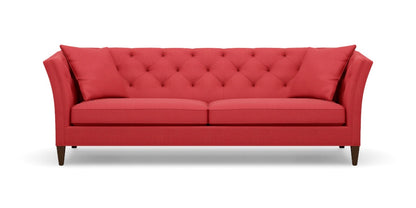 Introducing the Shelton 98" Sofa: a contemporary red sofa featuring a tufted backrest and two seat cushions. It showcases angled armrests, rests on four dark wooden legs, and comes complete with two coordinating red throw pillows at each end.