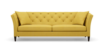 The Shelton 98" Sofa features a tufted backrest and two seat cushions in a mustard yellow color. It is designed with flair arms and rests on dark wooden legs.