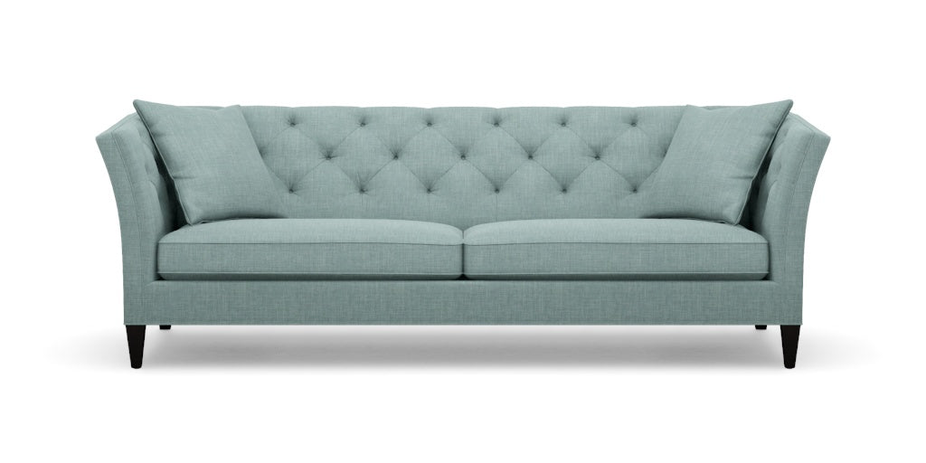 The Shelton 98" Sofa is teal with a tufted backrest and angled arms, featuring two seat cushions and four tapered black legs.