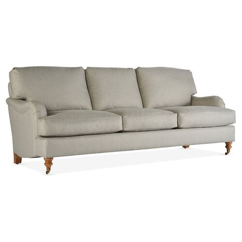 Introducing the Brooke 6-Seat Sofa: a light gray sofa enhanced with cushioned backrests and seats, complemented by wooden legs and rolled armrests for an elegant and comfortable appearance.