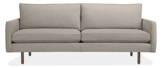 The 86" Jasper Sofa is a modern, light gray seating option with a clean and minimalist design. It features two seat cushions, two back cushions, and slim metal legs for support. With its sleek and contemporary appearance, it is well-suited for various living spaces.