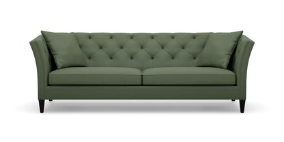 Introducing the Shelton 98" Sofa: a green tufted masterpiece accompanied by two matching cushions. This design boasts high arms and a sleek, modern aesthetic, complete with dark wooden legs and a cozy, plush appearance.