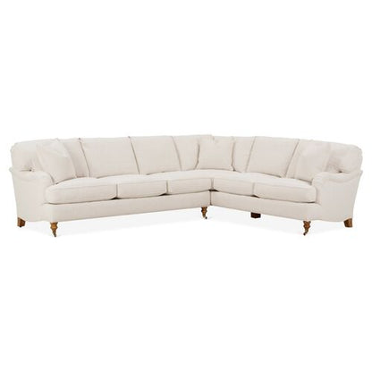 The Brooke 6-Piece Left-Facing Sectional is a spacious, L-shaped sofa with cream-colored upholstery. It includes cushioned backrests and seating, and rests on sturdy wooden legs.