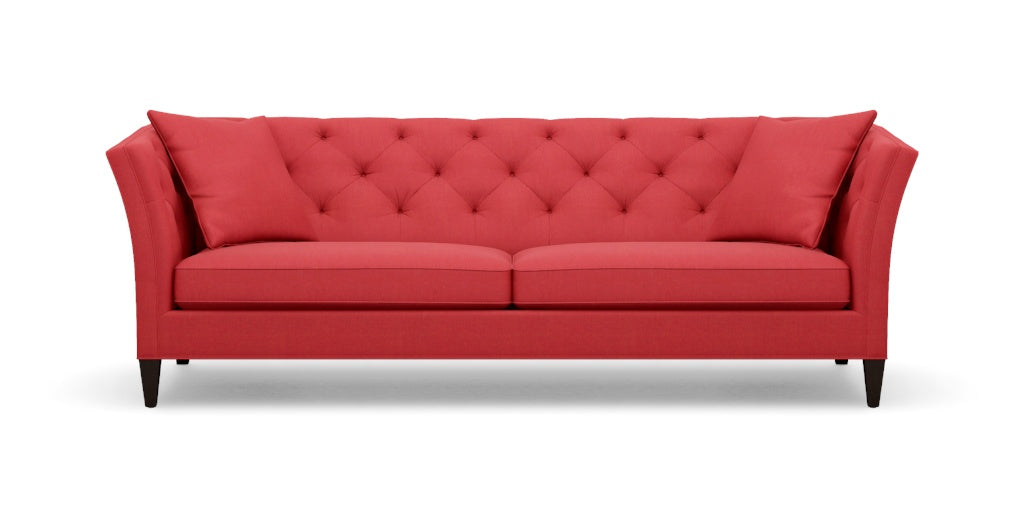 Introducing the Shelton 98" Sofa: a stunning red tufted design complete with two cushions, flared arms, and dark wooden legs, all showcased against a plain white background.