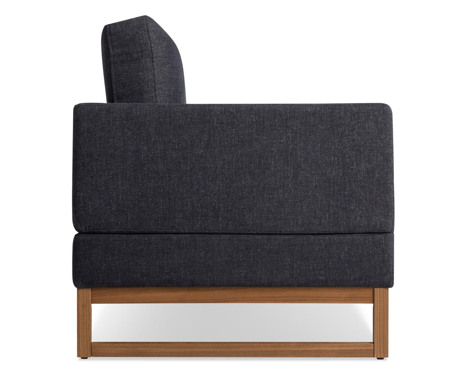 Side view of a modern dark gray armchair with a wooden base. The chair has a boxy, minimalist design.