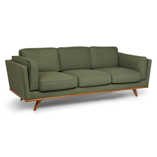 The Timber 90" Sofa is a green mid-century modern piece with three cushions and wooden legs. It showcases a minimalist design with angled armrests and a sturdy wooden frame, set against a plain white background.