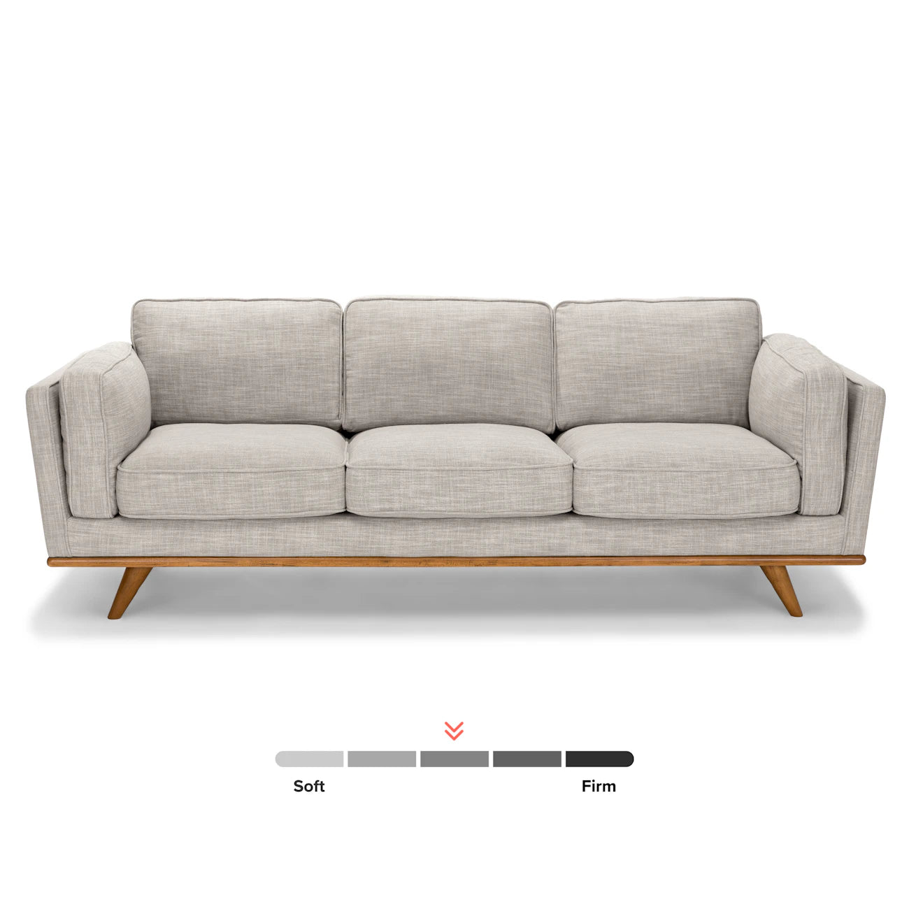 The Timber 90 Leather Sofa Charme Tan, featuring a light gray three-seater design with wooden legs, is displayed against a white background. Below the sofa, a firmness scale indicates that its cushion firmness leans slightly toward firm.