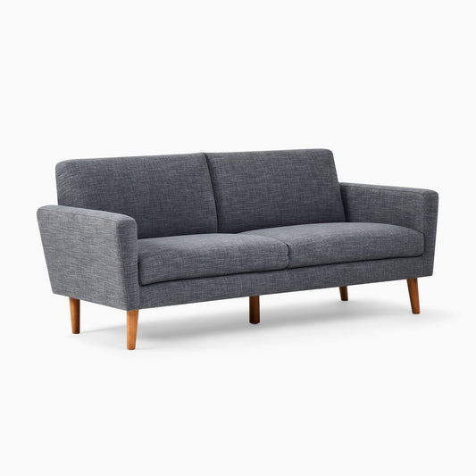 The Oliver Sofa, a modern piece with gray fabric, two cushions, and wooden legs, is displayed against a plain white background.