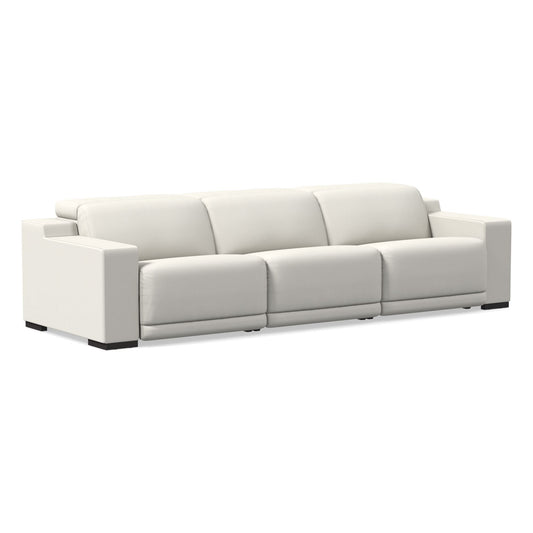 Introducing the Dalton Motion Sofa: a contemporary three-seater sofa crafted from white leather, featuring sleek rectangular armrests and a minimalist design. This sofa offers three cushioned backrests and seats, all elegantly set against a plain white backdrop.