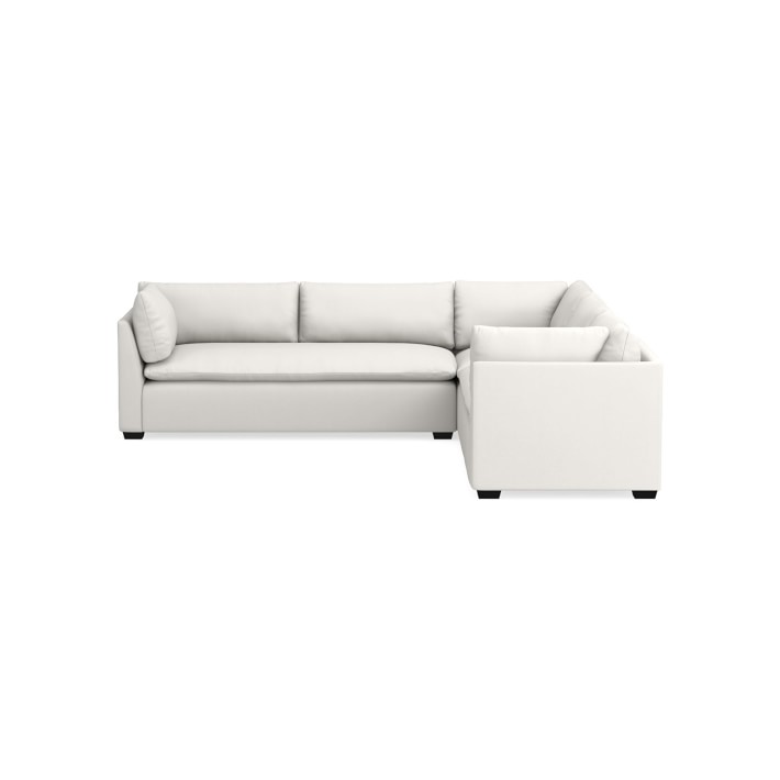 The Laguna 3-Piece L-Shape Loveseat Sectional is a contemporary white sectional sofa featuring clean lines and cushions, captured from an angled perspective. It boasts low square armrests and is displayed against a white backdrop.