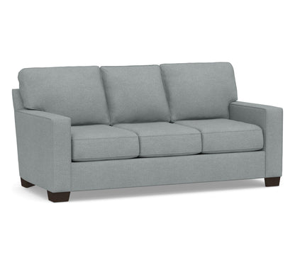 Introducing the Buchanan Square Arm Sleeper Sofa: a contemporary three-seater with light blue upholstery, rectangular cushions, straight armrests, and dark wooden legs.