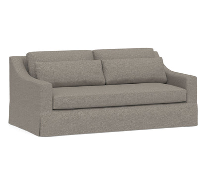 Introducing the York Slope Arm Deep Slipcovered Sofa: a gray upholstered loveseat characterized by its minimalist design, featuring two cushions and a subtly curved backrest. The sofa showcases textured fabric and straight, boxy armrests, offering a modern yet cozy appearance.