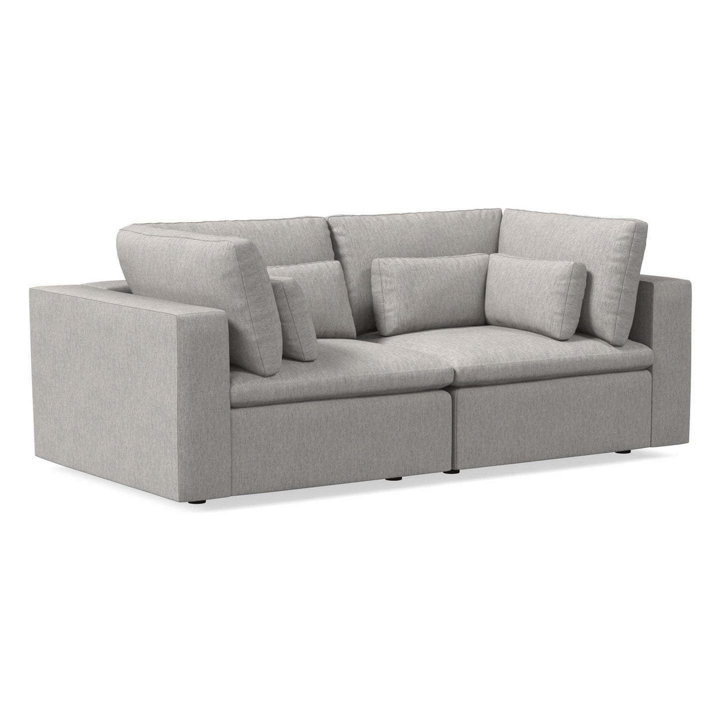 Introducing the Harmony Modular 3 Piece Sofa, a contemporary light gray sofa with a boxy design. It showcases thick cushions and a low profile, complemented by a wide armrest on the left and backrests with pillows designed for ultimate comfort.