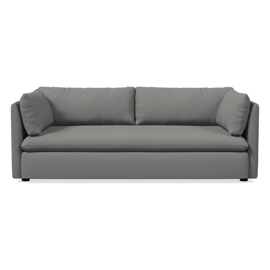 Introducing the Shelter Sleeper Sofa, a contemporary gray piece with plush cushions and a sleek, minimalist design. It includes two large back cushions and angled armrests, providing a comfortable and stylish seating solution. The sofa sits on a flat base supported by small black legs.