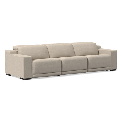 Introducing the Dalton Motion Sofa: a modern three-seater in beige, featuring wide armrests and a sleek design. Set against a plain white background, this sofa boasts soft fabric upholstery and sturdy blocky black legs, exuding a minimalist and contemporary aesthetic.