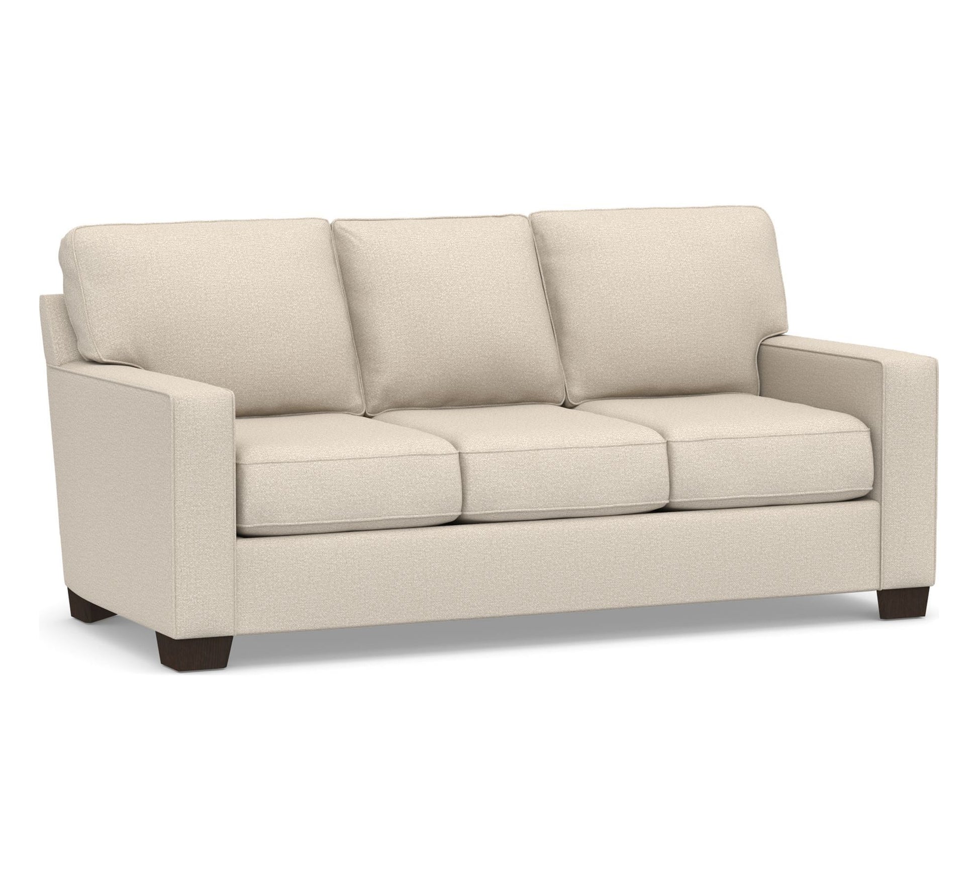 The Buchanan Square Arm Sleeper Sofa is a beige, three-seater sofa featuring square arms and dark wooden legs. Its plush cushions are neatly aligned, providing a comfortable and modern appearance. The plain white background effectively highlights the design of the sofa.