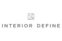 Logo of Interior Define. It features a minimalist design with the company's name in uppercase letters below a small square containing the initials "I" and "D" separated by a diagonal line. The logo is displayed in a gray color on a white background.