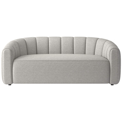 A stylish and contemporary green velvet loveseat, featuring a curved backrest with vertical channel tufting. The Fitz 72.5" Channeled Loveseat boasts a sleek, minimalist design and is beautifully set against a white background.