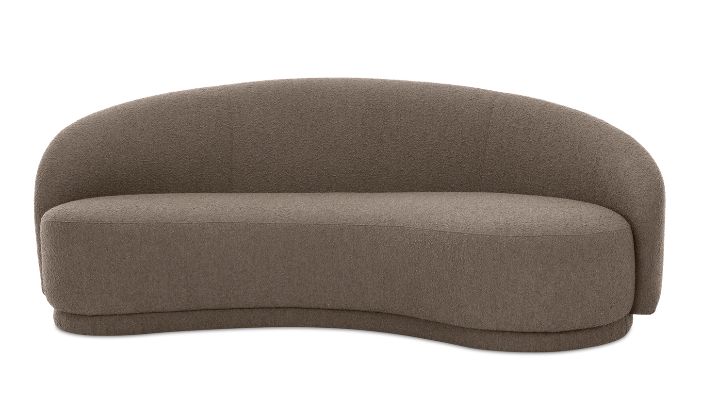 Introducing the Excelsior Sofa Cream: a cream-colored loveseat with a curved back, plush textured upholstery, and a modern minimalist design. Its gently curving base perfectly complements its sleek overall aesthetic.