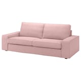 The KIVIK Sofa in light pink features square armrests and two seat cushions.